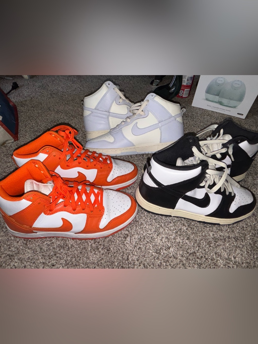 Three pairs of Nike High-Top Sneakers in Orange, White, Black, and Light Purple